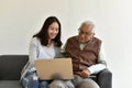 Asian family relationship, Daughter and elderly father using laptop computer together.