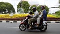 family riding motorcycle on the road