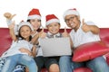 Asian family with thumbs and laptop at Christmas Royalty Free Stock Photo