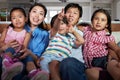 Asian Family Sitting On Sofa Watching TV Together Royalty Free Stock Photo