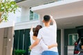 Asian family standing outside with their new house and car carrying boxes. Royalty Free Stock Photo