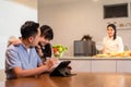 Asian family stay home, Little child look at father work in kitchen. Happy Attractive loving Father and young daughter use tablet Royalty Free Stock Photo