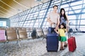 Asian family with suitcases at airport Royalty Free Stock Photo