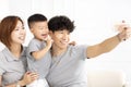 asian family taking selfie on sofa Royalty Free Stock Photo