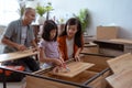 asian family at their new house buying and assembling new furniture. Royalty Free Stock Photo