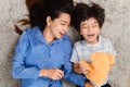 Asian family togetherness at home. Mom and kid playing as doctor together in living room. Lifestyle and family