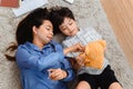 Asian family togetherness at home. Mom and kid playing as doctor together in living room. Lifestyle and family