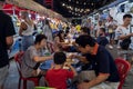 Asian family tourists eat local thai food on the street at phuket market, Thailand, Phuket, December 30, 2019.
