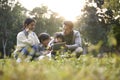 Happy asian family having a good time outdoors in city park Royalty Free Stock Photo