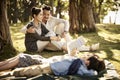 Asian family with two children relaxing in park Royalty Free Stock Photo
