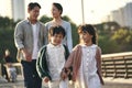 Asian family with two children taking a walk in city park Royalty Free Stock Photo