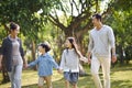 Asian family with two children walking relaxing in park Royalty Free Stock Photo