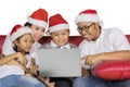 Asian family using a laptop at Christmas time Royalty Free Stock Photo