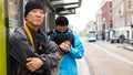 Asian family waiting for bus at bus stop in Europe travel trip