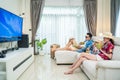 Asian Family watch TV screen, pretend on beach during summer in house. Happy Traveller people having fun stay at home, Parent