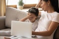 Asian family watching cartoons on laptop making facepalm feels embarrassment Royalty Free Stock Photo