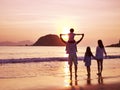 Asian family watching sunrise on beach Royalty Free Stock Photo
