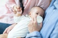 Asian family young father and mother feeding milk baby boy at home. Portrait of asian young couple father mother holding new born Royalty Free Stock Photo