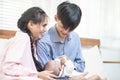 Asian family young father and mother feeding milk baby boy at home. Portrait of asian young couple father mother holding new born Royalty Free Stock Photo