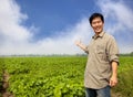 Asian farmer showing his farm