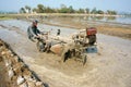 Asian farmer, Vietnamese rice field, tractor plough