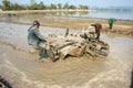 Asian farmer, Vietnamese rice field, tractor plough