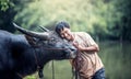 Asian farmer and water buffalo in farm Royalty Free Stock Photo