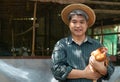 Asian farmers are holding hens. At a chicken farm in their own home area With a happy gesture Royalty Free Stock Photo