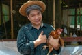 Asian farmers are holding hens. At a chicken farm in their own home area With a happy gesture Royalty Free Stock Photo