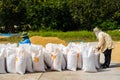 Asian farmers working, drying spreading grains under the sun