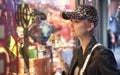 Asian fashion beauty smiling & looking into store window when shopping in holiday