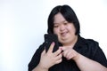 Asian fat girl with disabilities or children with Down syndrome Playing on the phone and smiling happily on white background. Royalty Free Stock Photo