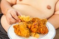 Asian fat man eating fried chicken Royalty Free Stock Photo