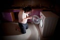 Asian fat man kneel in prayer by washing machine Royalty Free Stock Photo
