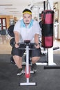 Asian fat man using an exercise bike for weight loss Royalty Free Stock Photo