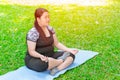 Asian fat plus size girl sitting Yoga on mat