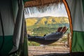 Asian fat traveler sleeping on the hammock with beautiful mountain view of Sapan Village At nan Thailand.