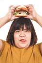 Asian fat woman eats a large hamburger. White background