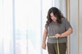 Asian fat women are sad because of  increase in size after checking with a tape measure Royalty Free Stock Photo