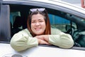 Asian fat woman smiling brightly drive a car Happy holidays