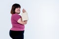 Asian fat woman standing and Holding a paper bag on white background