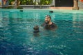 Asian father with a beard and young daughter in the swimming pool. Royalty Free Stock Photo