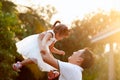 Asian father carrying his daughter up in the air and playing together in the park Royalty Free Stock Photo