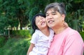An Asian father is carrying a lovely daughter to her chest. Both the father and daughter smiled happily. Asia family and love conc