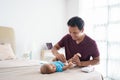 asian father changing his infant baby diaper Royalty Free Stock Photo