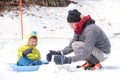 Asian dad and son playing happily in snow during winter holiday vacation Royalty Free Stock Photo