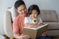 Asian father and daughter read books the floor in the house, Self-learning concept Royalty Free Stock Photo