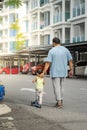 Asian father and daughter walking  and playing on the road at the day time. People having fun outdoors. Concept of friendly family Royalty Free Stock Photo