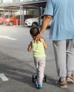 Asian father and daughter walking  and playing on the road at the day time. People having fun outdoors. Concept of friendly family Royalty Free Stock Photo