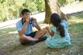 Asian father getting ready to take photo of his kid on field